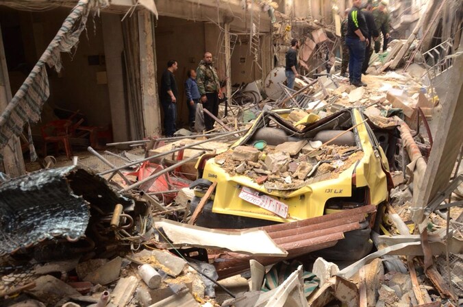 Een verwoeste straat in een christelijke wijk in de Syrische stad Aleppo. Foto uit april 2015.
