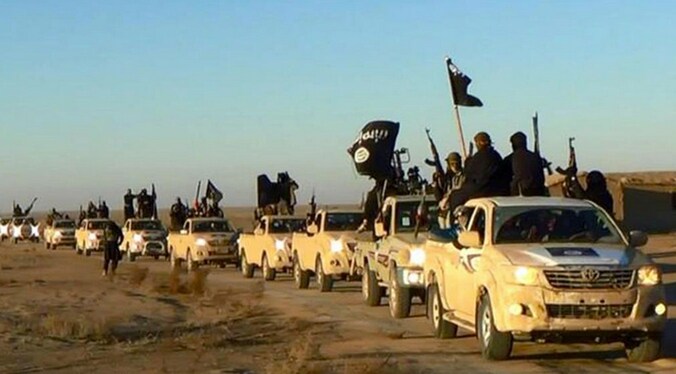 IS-strijders bij de inname van de Syrische stad Raqqa, in juni 2014.