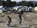 Syrische vluchtelingen tillen hun persoonlijke spullen uit het vluchtelingenkamp zodat ze overgeplaatst kunnen worden naar een nieuwe opvang.