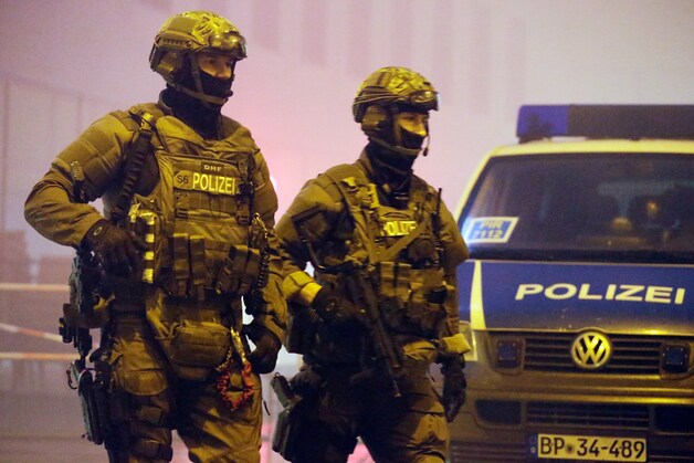 Zwaarbewapende agenten patrouilleren voor het station van Pasing in München.