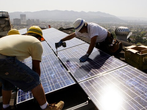 Technici plaatsen zonnepanelen op dak in het Californische Glendale.
