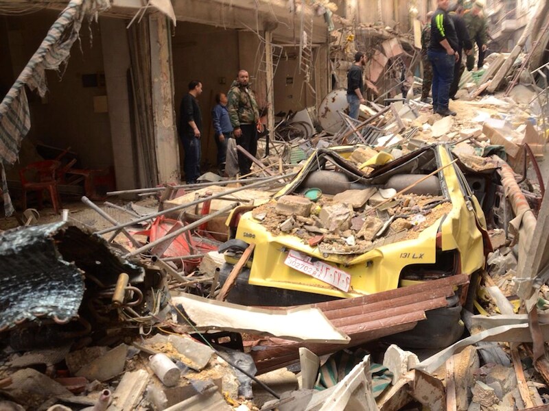 Een verwoeste straat in een christelijke wijk in de Syrische stad Aleppo. Foto uit april 2015.