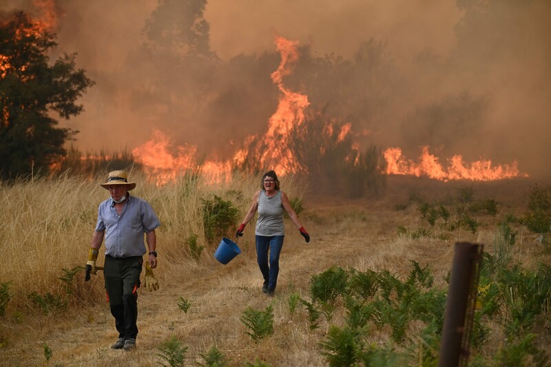 People try to extinguish a wildfire in northwestern Spain. Image from last August.