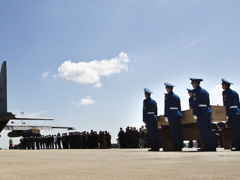 De lichamen worden aan boord gedragen na een korte ceremonie.